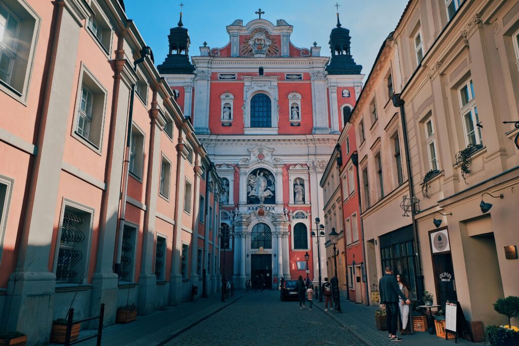 Stunning Baroque architecture of Poznań Fara captured in a vibrant street setting.